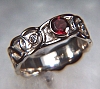 Sculpted Celtic ring with bezel set garnet and 2 diamonds